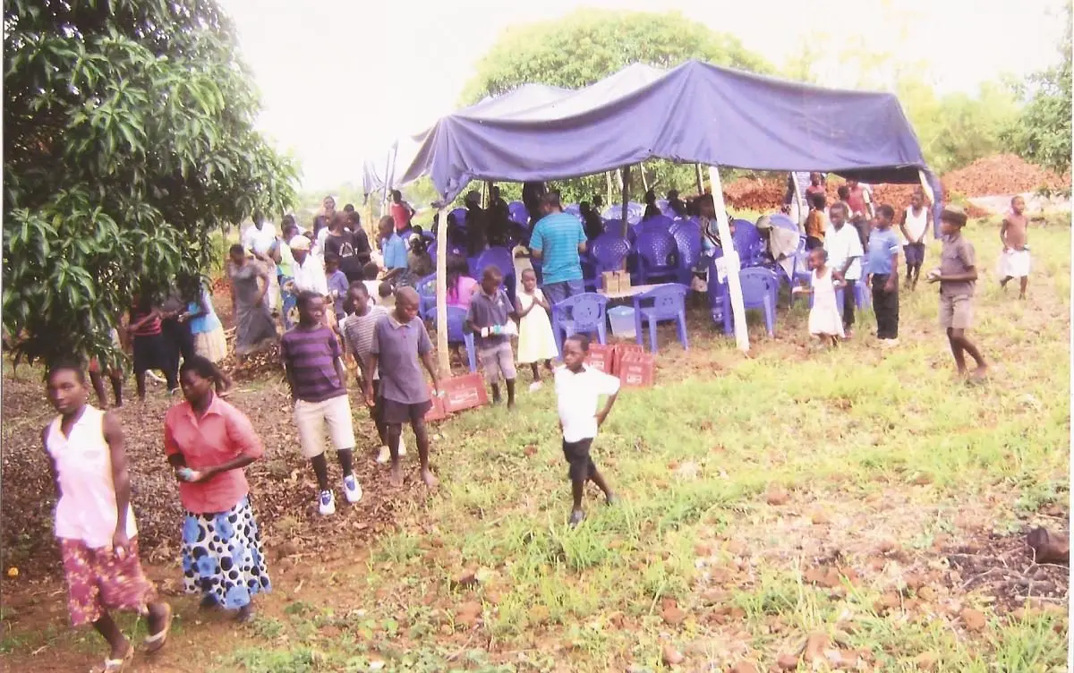 Children arriving at the tent for a shared meal