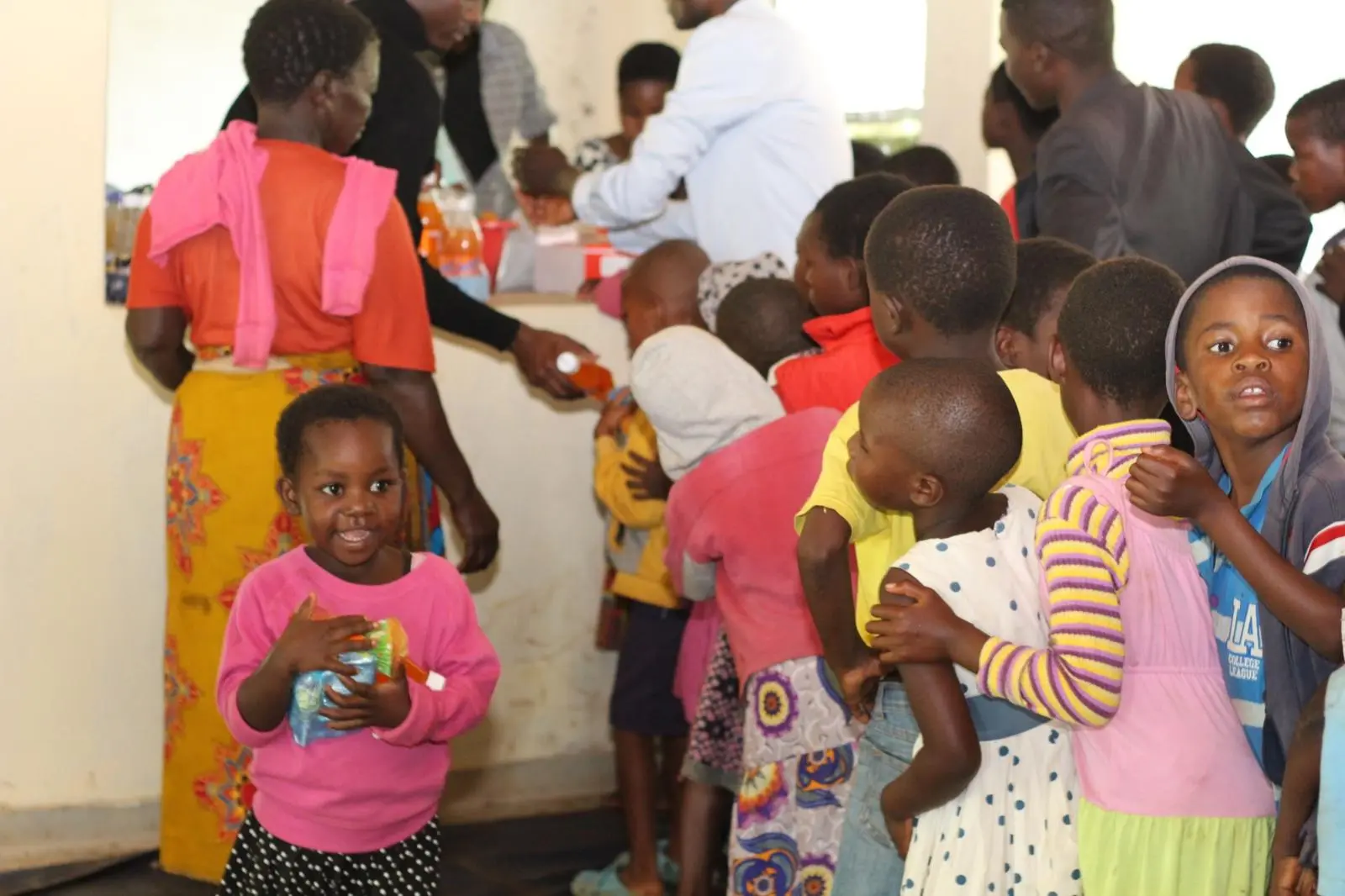 Children queuing for a meal at the centre