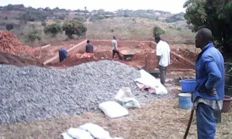 Volunteers digging the foundation trenches for the feeding hall