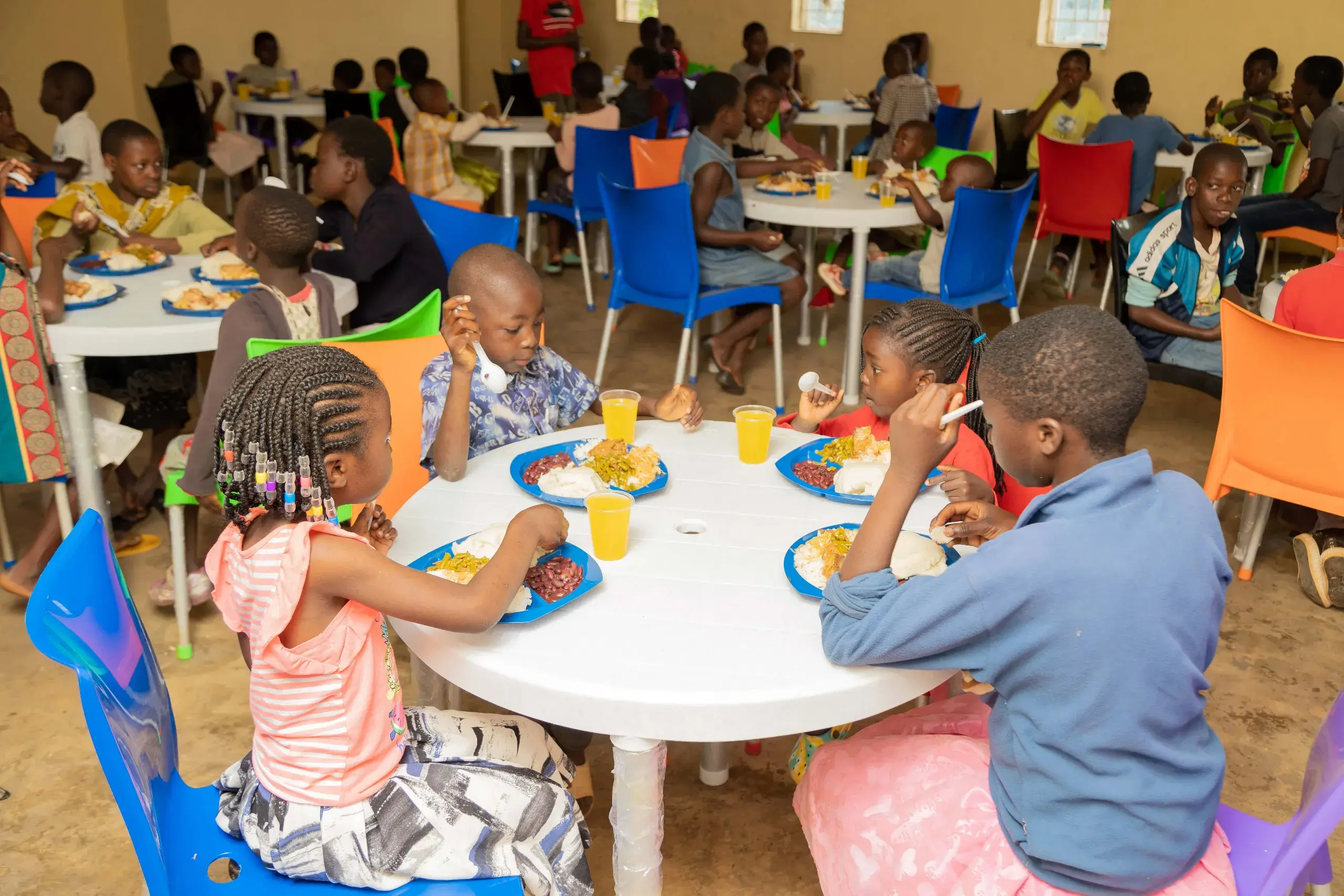 A child enjoying a nutritious meal served at the feeding hall