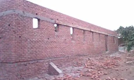 The feeding hall walls being built up in brick, with window openings formed