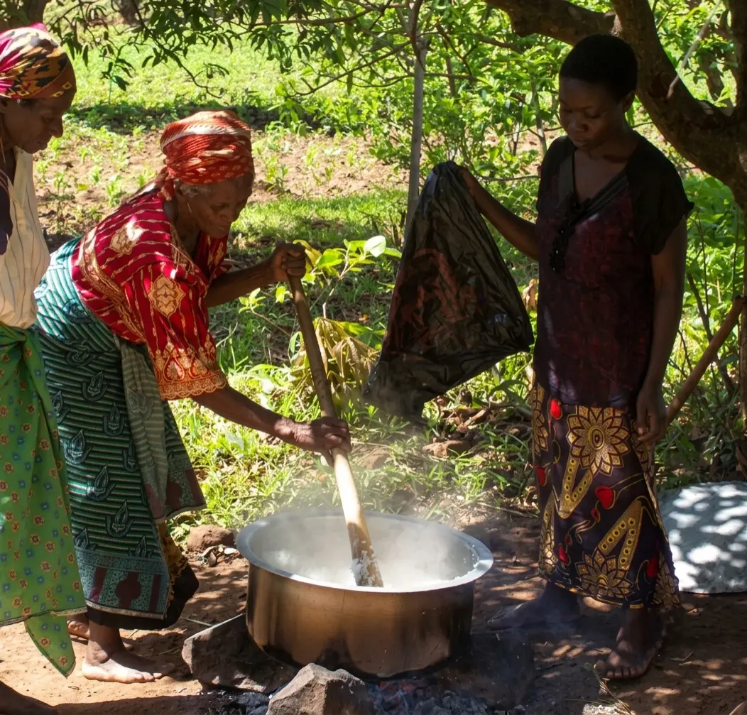 Women from the surrounding community preparing food for the children